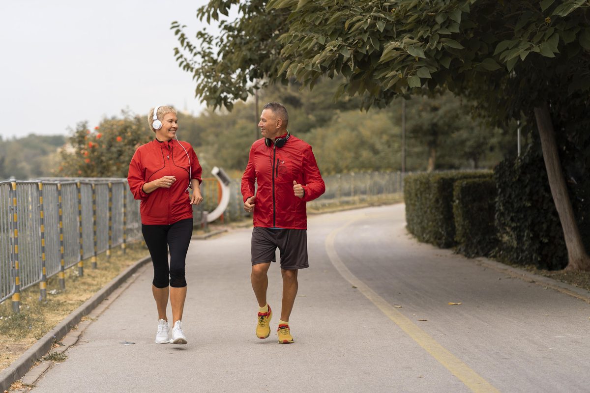 front-view-senior-couple-jogging-together-outside-park